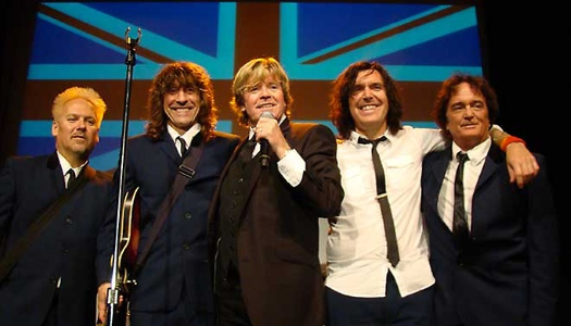 Peter-Noone-with-Herman's-Hermits-poster-with-British- Flag-behind-the- group