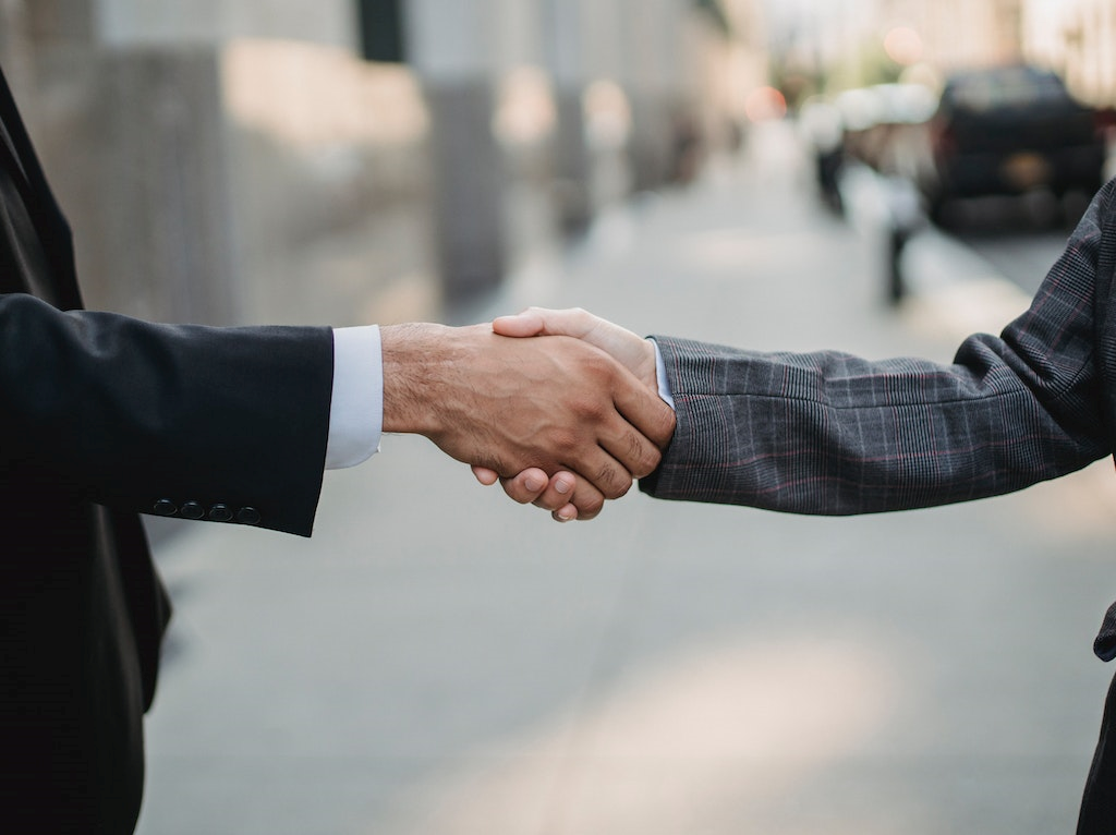 two-men-in-business-suits-shaking-hands