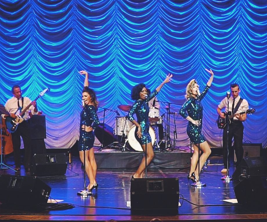The Lovettes singing and dancing